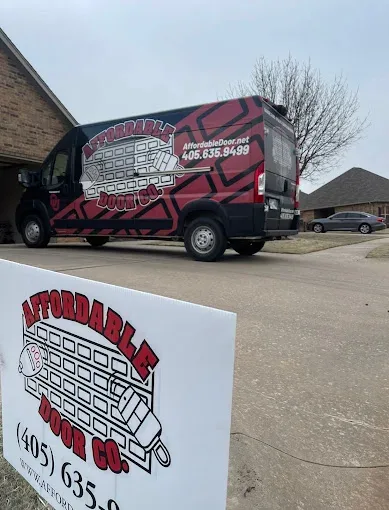 Affordable Door Co van and yard sign at job site in Oklahoma City metro area
